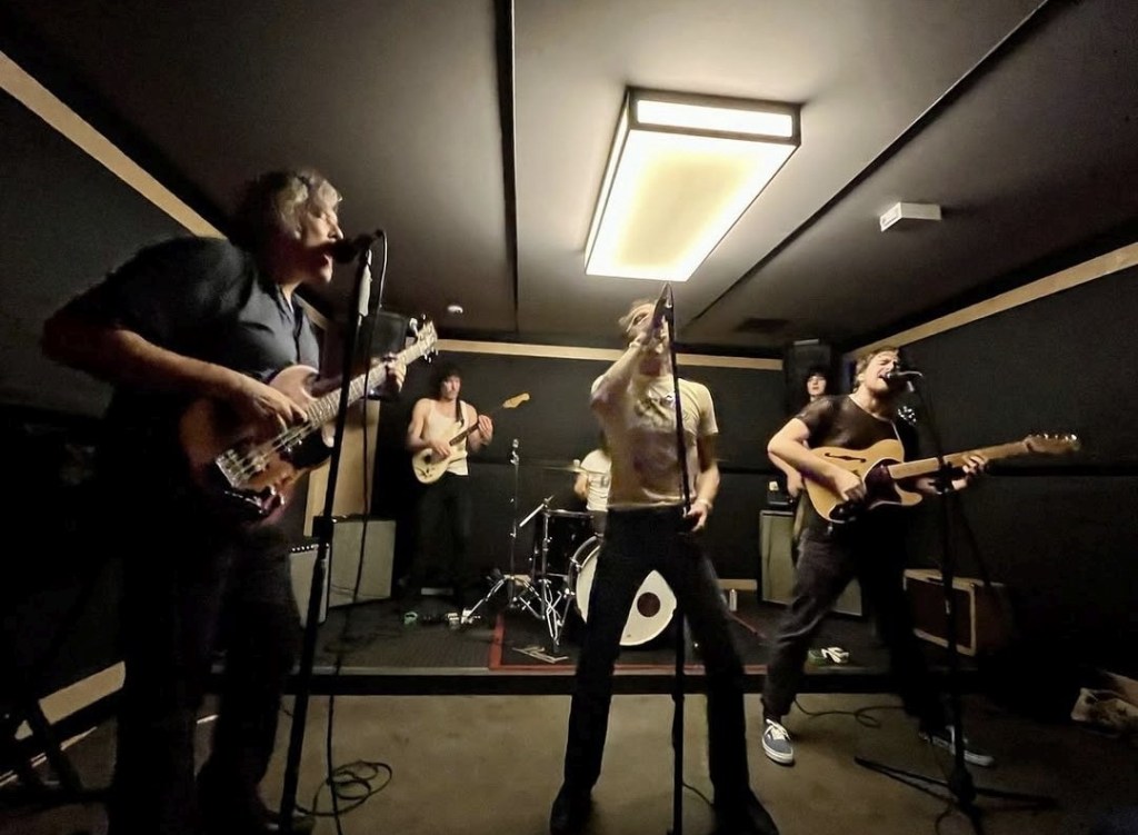 Photo of members of the band Apache in rehearsal space practicing in New York City in 2022.