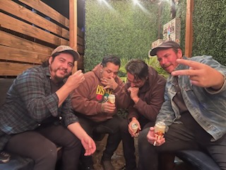 Band shot of El Paso band Travi and the Travettes, two members smile and look at the camera while the other two hide their faces.