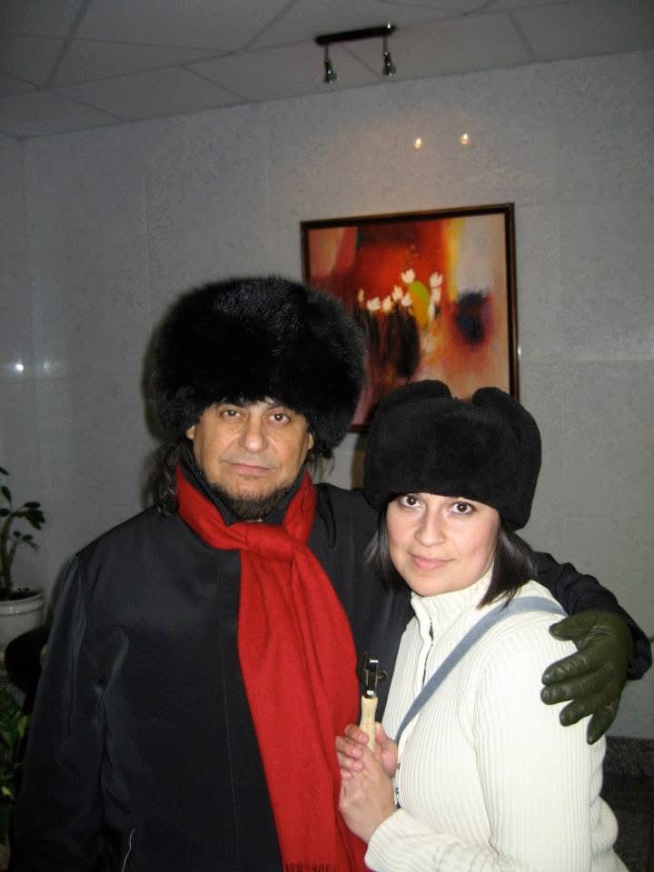 Photo of Olivia "Tina" Torres, right, and her uncle Tito Larriva, both wearing black furry hats.
