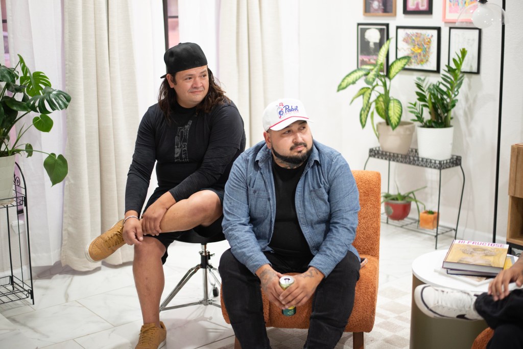 Photo of Bloomwave drummer Alex Hernandez, left, and bassist Chris Lopez, sitting in a living room, discussing the band. Photo by Omar Mena.