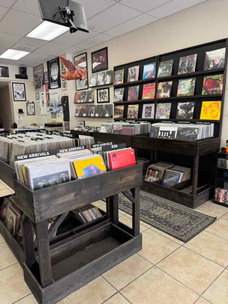 Photo of the interior of Sound Decay Records, a record store located in downtown El Paso, TX. The photos features shelves of records.